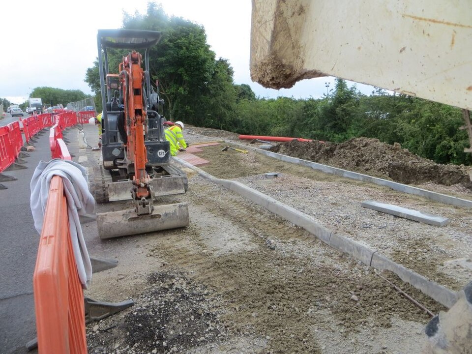 A photo of a builder, cropped so badly his head is out of shot
